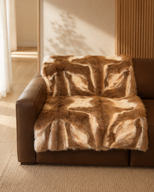 Close view of the alpaca wool blanket on a brown sofa