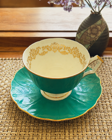 Close view of Aynsley turquoise teacup with gold interior decoration