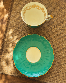 Top view of Aynsley turquoise teacup and saucer with scalloped saucer