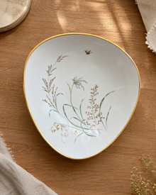 Oval porcelain bowl with delicate grass motif and gold rim