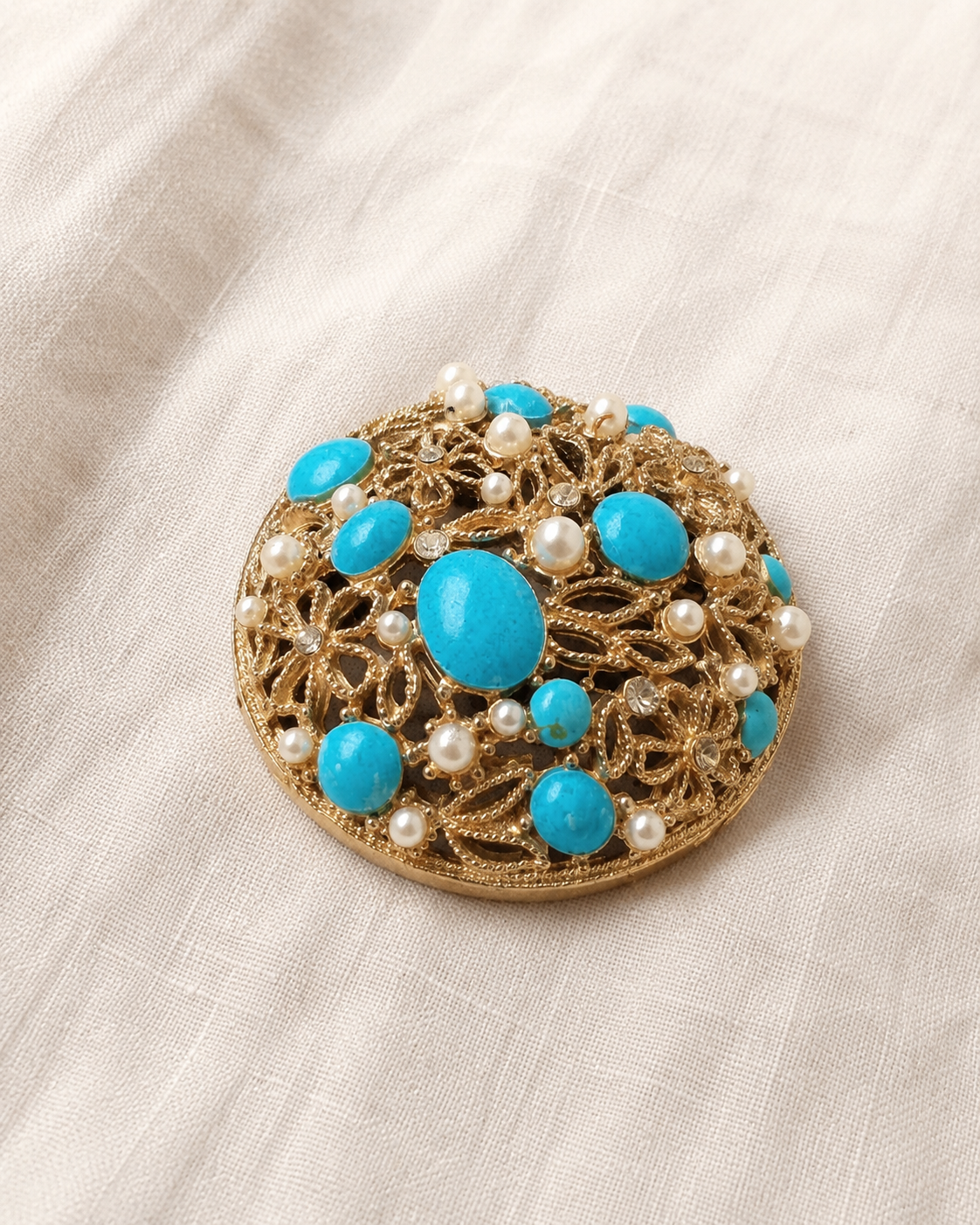 Blue cabochon pearl and rhinestone brooch on linen