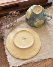 Blue floral ceramic saucer with raised painted details