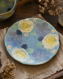 Maker mark on underside of blue floral teacup and saucer
