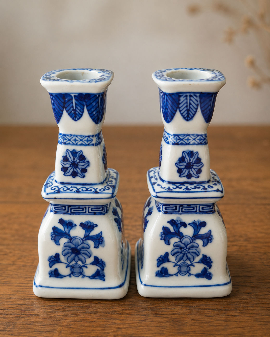 Pair of blue and white porcelain candlesticks with floral decoration