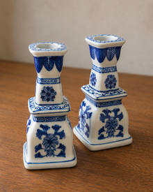 Angled view of blue and white porcelain candlestick pair