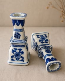 Blue and white porcelain candlesticks shown upright and on side