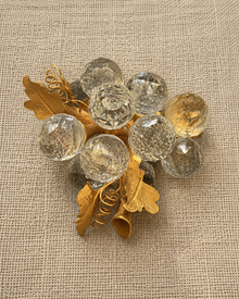 Top view of faceted glass-look grape cluster brooch