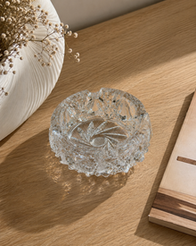 Cut crystal ashtray styled on a sunlit desk