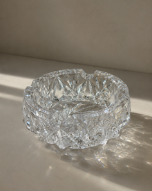 Top view of cut crystal ashtray on stone tray