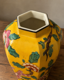 Close view of the hexagonal opening on yellow hand-painted ceramic vase