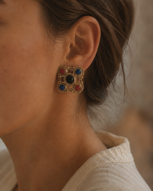 Gem-tone clip earring worn on the ear