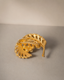 Back view of gold-tone faux pearl leaf brooch with pin clasp