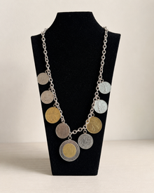 Front view of Italian lire-style coin charm necklace with mixed metal coins