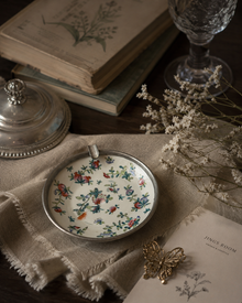 Japanese porcelain catchall styled with linen, books, and dried flowers