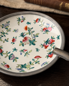 Close view of the floral painting inside the porcelain catchall