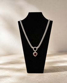 Red heart pendant necklace displayed on a black jewelry bust