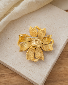 Back view of the gold-tone flower brooch with pin hardware