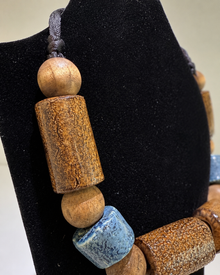 Close view of wood and blue ceramic-style beads